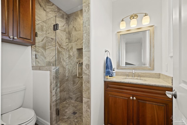 full bathroom featuring a stall shower, vanity, and toilet