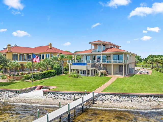 back of property featuring a lawn, a deck with water view, and central AC unit