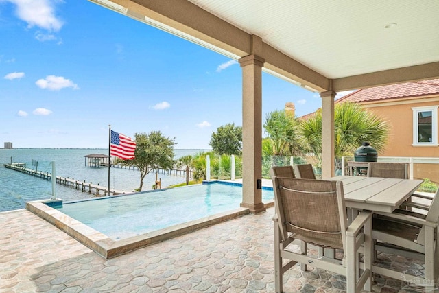 view of pool with a water view, an infinity pool, a patio area, and outdoor dining area