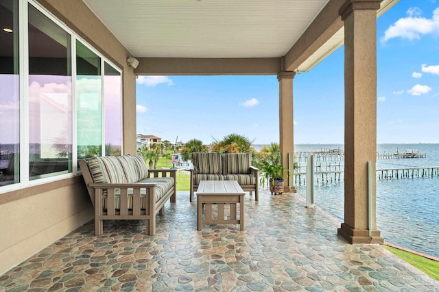 exterior space with an outdoor hangout area and a water view