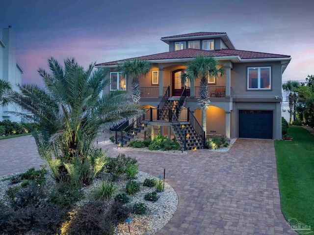 view of front of property with covered porch and a garage