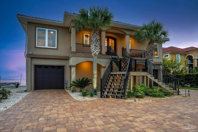 view of front of property with covered porch and a garage