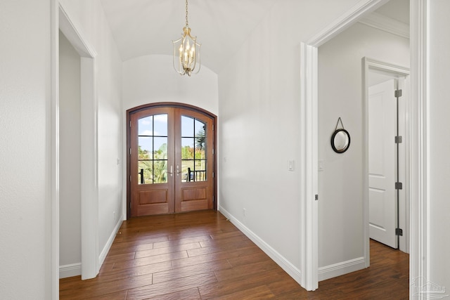 entrance foyer with arched walkways, dark wood-style flooring, french doors, lofted ceiling, and baseboards