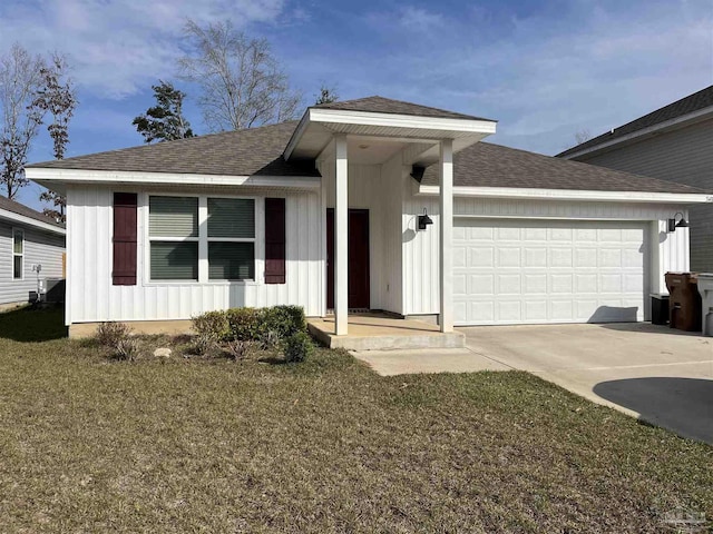 single story home featuring a shingled roof, an attached garage, board and batten siding, a front yard, and driveway