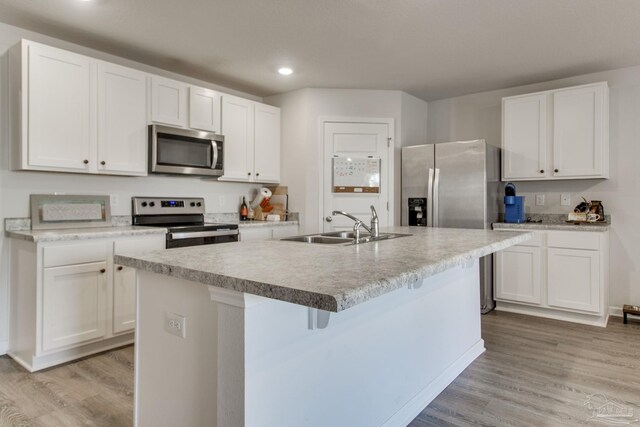 kitchen with white cabinetry and appliances with stainless steel finishes