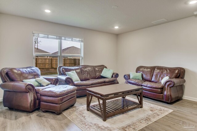 living room featuring recessed lighting, visible vents, and light wood-style flooring