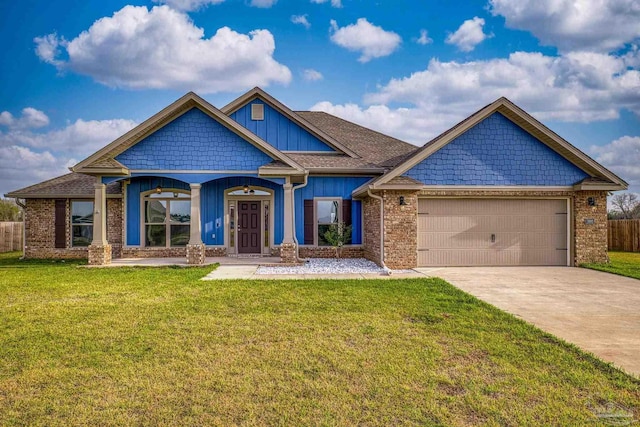 craftsman-style home with driveway, a garage, fence, and a front lawn