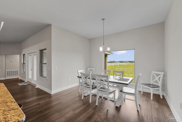 dining area with baseboards, visible vents, and dark wood-style flooring