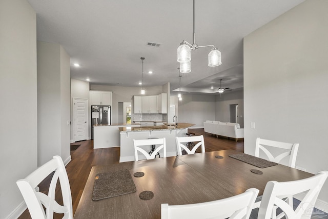 dining space featuring recessed lighting, dark wood-type flooring, baseboards, and visible vents
