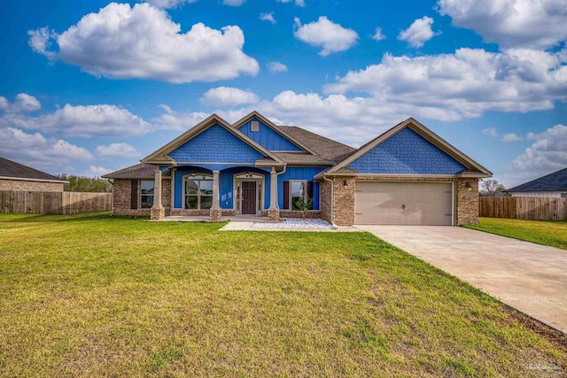 craftsman-style house with a front yard, driveway, fence, and an attached garage