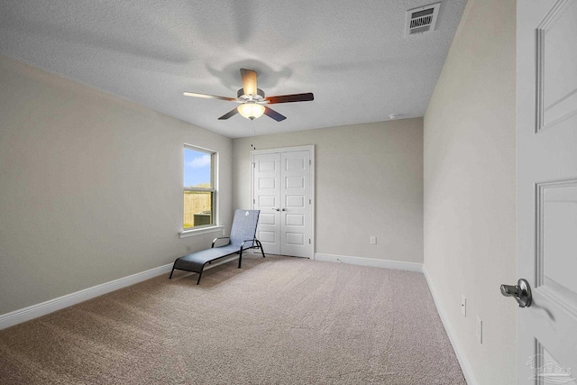 unfurnished room featuring baseboards, ceiling fan, visible vents, and carpet