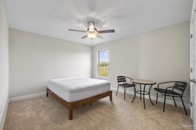carpeted bedroom with baseboards and ceiling fan