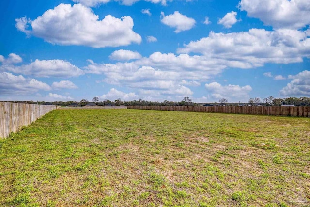 view of yard featuring fence and a rural view