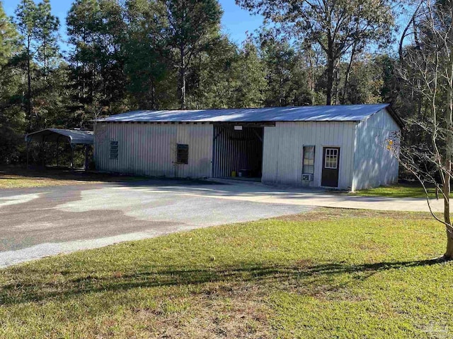 view of outbuilding with a yard