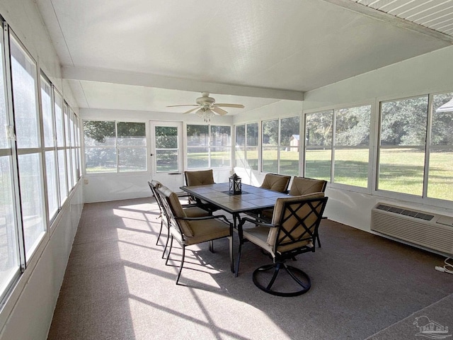 sunroom featuring a wealth of natural light, a wall mounted AC, and ceiling fan