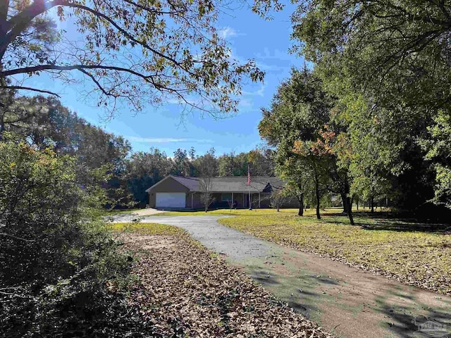 view of front of house with a garage and a front yard