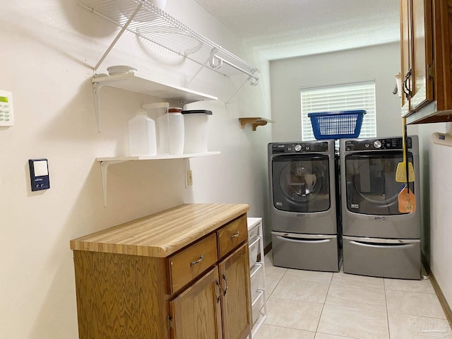 washroom featuring light tile patterned floors and washing machine and clothes dryer