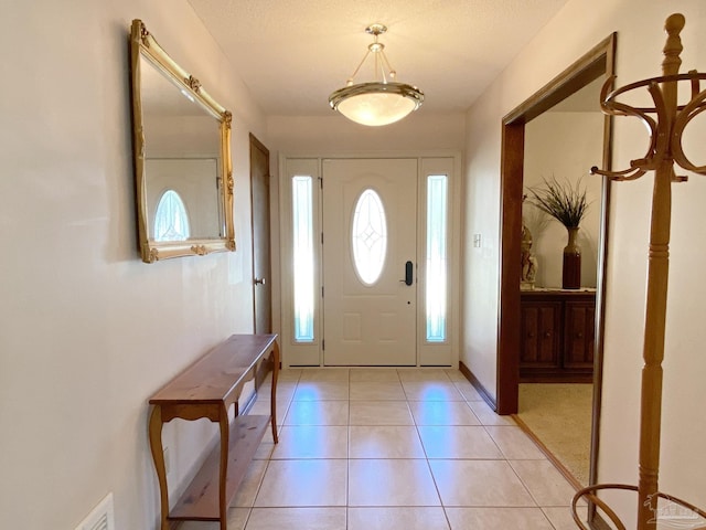 foyer entrance featuring light tile patterned floors