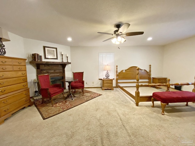 bedroom with carpet flooring, a textured ceiling, and ceiling fan