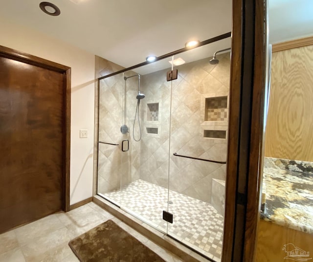 bathroom with a shower with shower door