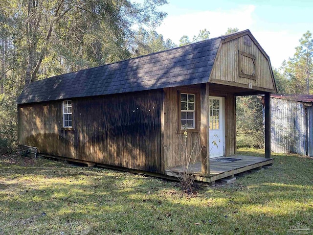 view of outbuilding featuring a yard