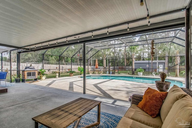 view of swimming pool with a lanai and a patio area