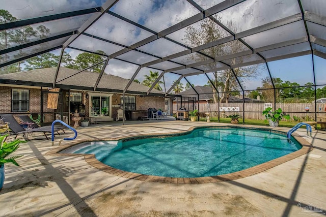 view of swimming pool featuring glass enclosure and a patio area