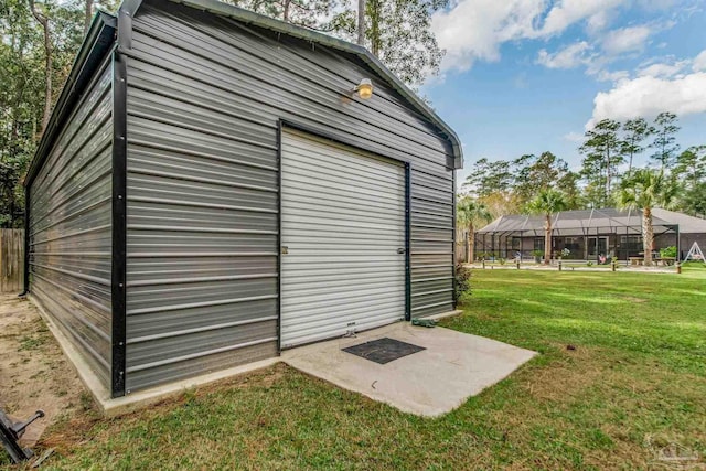 view of outbuilding with a garage and a yard