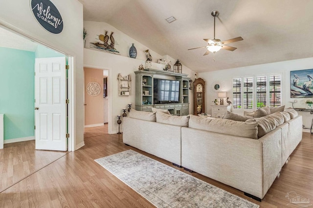 living room with ceiling fan, high vaulted ceiling, and wood-type flooring