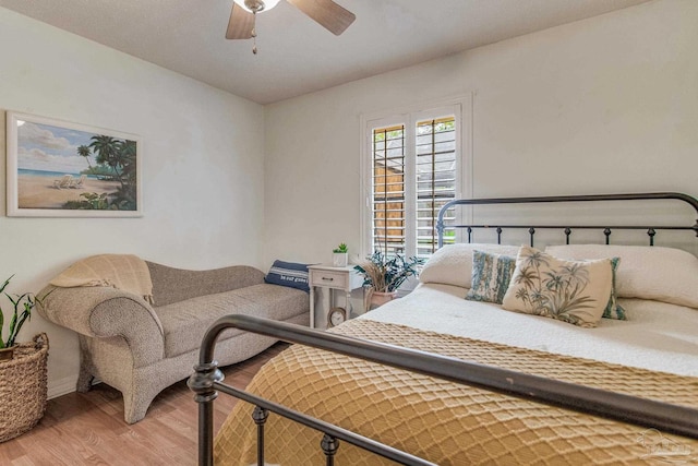 bedroom with ceiling fan and hardwood / wood-style flooring