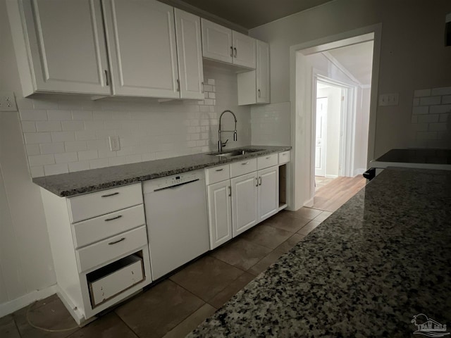 kitchen with stone countertops, dishwasher, sink, and white cabinetry