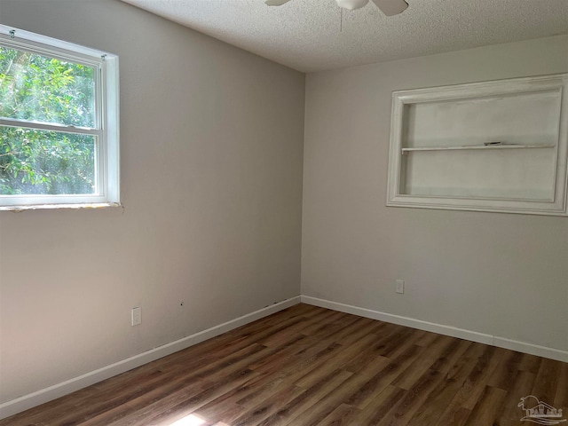 unfurnished room with ceiling fan, a textured ceiling, and dark hardwood / wood-style floors