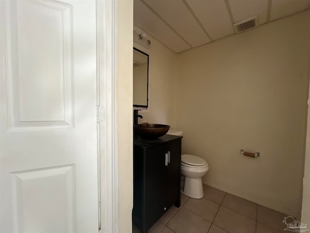 bathroom featuring tile patterned floors, vanity, and toilet