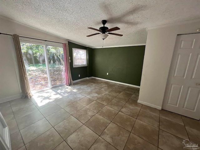 empty room featuring ceiling fan, a textured ceiling, vaulted ceiling, and tile patterned floors