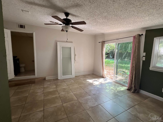 tiled empty room featuring ceiling fan and a textured ceiling