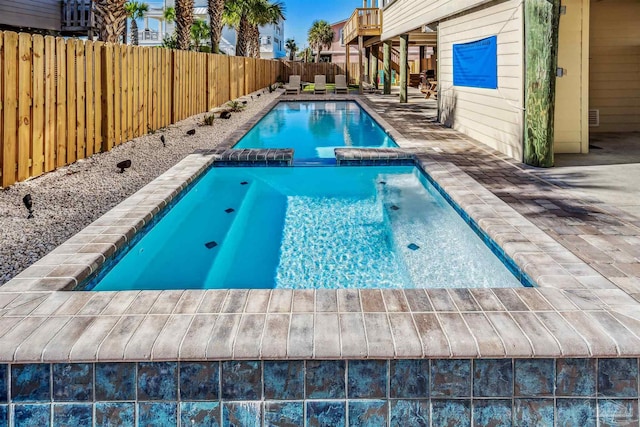 view of swimming pool with an in ground hot tub and a patio area