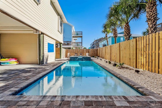 view of pool featuring an in ground hot tub and a patio