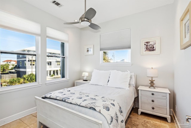 tiled bedroom with ceiling fan