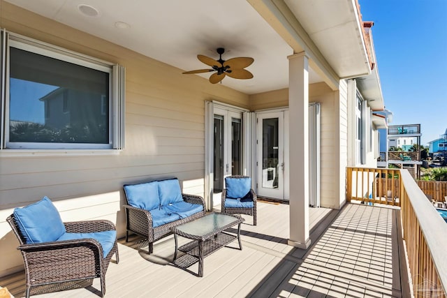 wooden deck with ceiling fan and an outdoor hangout area