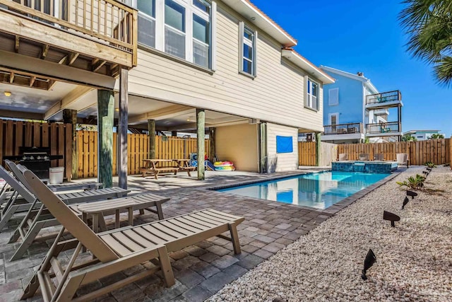 view of swimming pool with an in ground hot tub and a patio