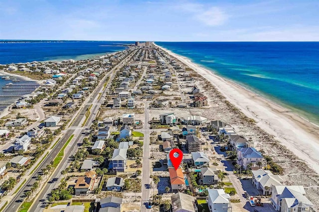 drone / aerial view featuring a water view and a beach view