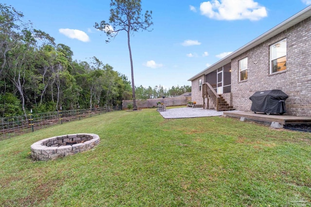 view of yard with a patio and an outdoor fire pit