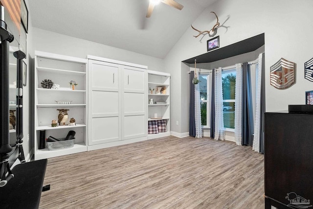 interior space with wood-type flooring, ceiling fan, and lofted ceiling