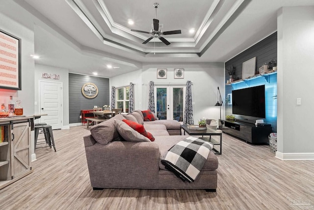 living room with ceiling fan, french doors, light hardwood / wood-style floors, and ornamental molding