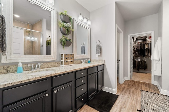 bathroom featuring vanity, wood-type flooring, and a shower with shower door