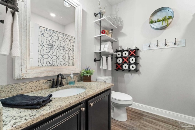 bathroom with vanity, hardwood / wood-style flooring, and toilet