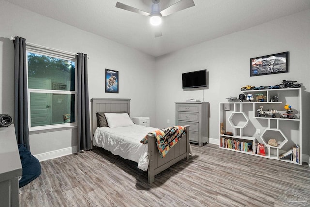 bedroom with wood-type flooring and ceiling fan