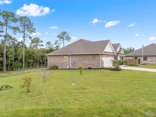 view of home's exterior with a garage and a lawn