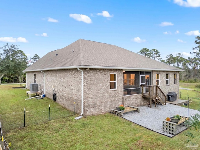 rear view of house featuring a yard