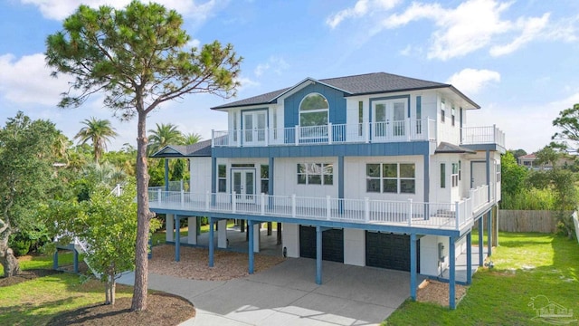 view of front of property with a carport, a balcony, and a front lawn